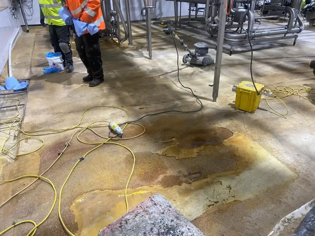 Liquid DPM applied to a prepared concrete floor before the flooring system